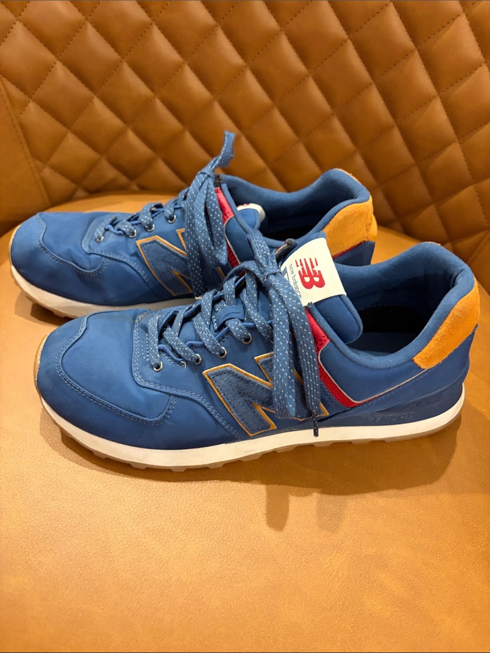 New Balance Blue Athletic Sneakers with Orange Heel and Red Accent